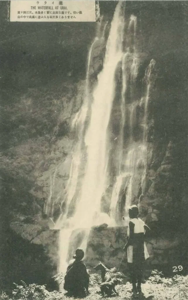 這張照片拍攝的是烏來瀑布（日治時期稱「ウライ瀧」）。照片中兩人在瀑布下方顯得極其渺小，展現了瀑布高達 80 公尺的震撼落差。